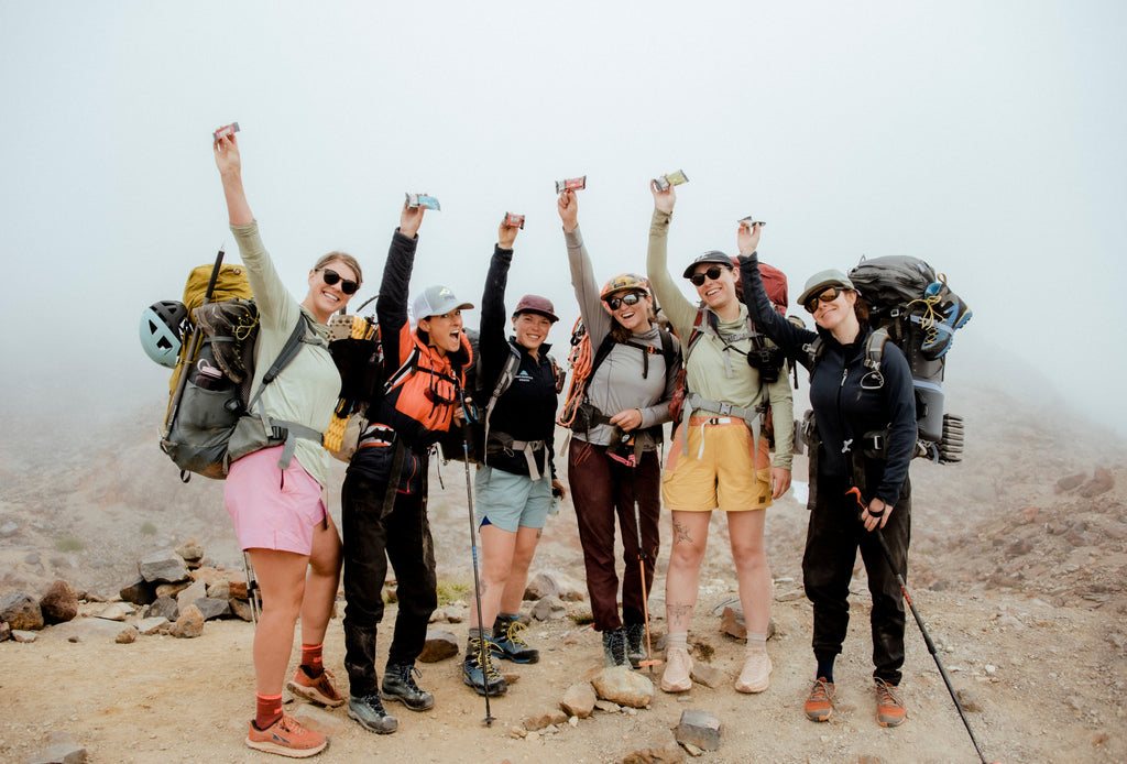 hikers holding Kate's Real Food organic snack bars